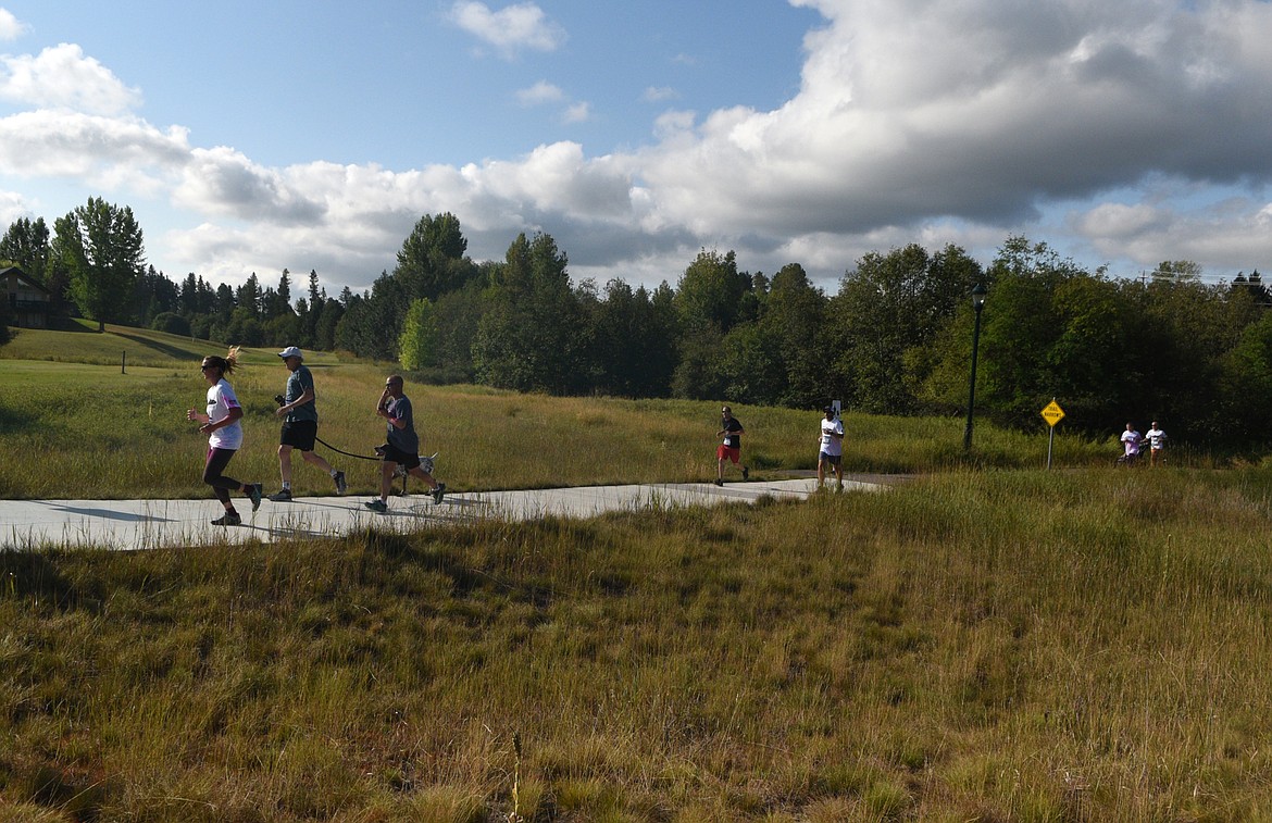 Runners make their way along the bike path Saturday morning during the Great Fish Community Challenge Color Run through Whitefish. (Heidi Desch/Whitefish Pilot)