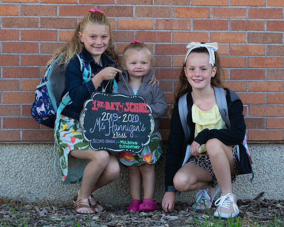 Kendall Wermling, her sister, and Isabella Jemming prepare for Ms. Hannigan&#146;s second grade class on the first day of school. (Daniel McKay/Whitefish Pilot)