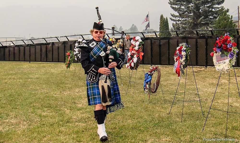 Mike Gilbert pipes in front of the Vietnam Traveling Memorial Wall when it made a stop in Kalispell in 2017. (Courtesy of Mike Gilbert)