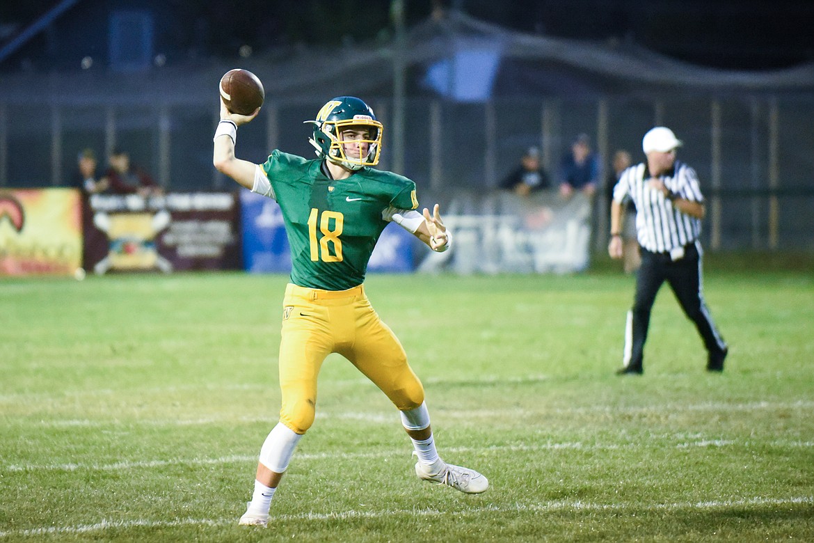 Fynn Ridgeway fires a pass on the run during Friday&#146;s home opener against Libby. (Daniel McKay/Whitefish Pilot)