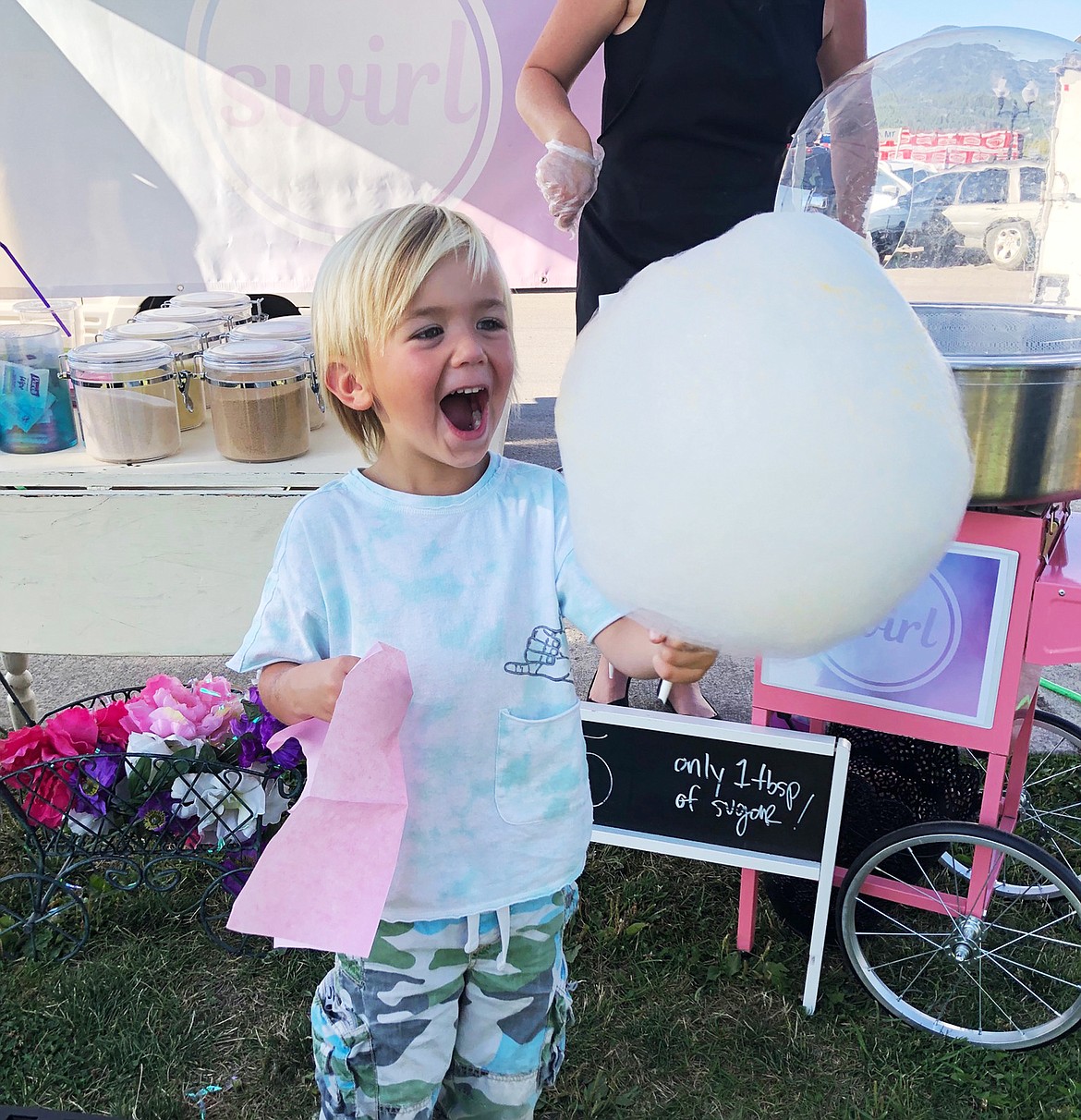 Hendrix Richardson is excited as to taste cotton candy for the first time from Swirl at the Whitefish Farmer Market. (Courtesy photo)