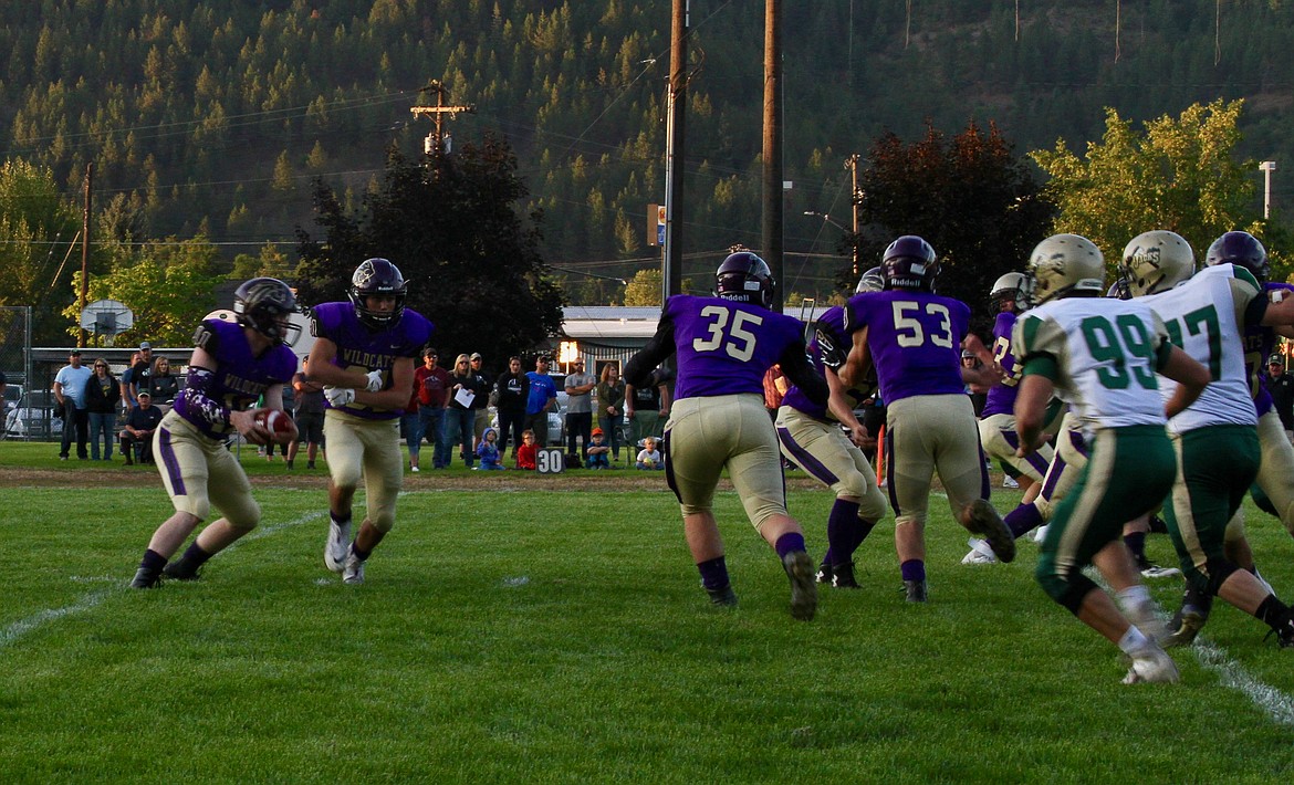 Photo by Rad Groth/ Kellogg quarterback Brandon Miller fakes a handoff to Taylor Bush during the first quarter of Kellogg&#146;s game against St. Maries.