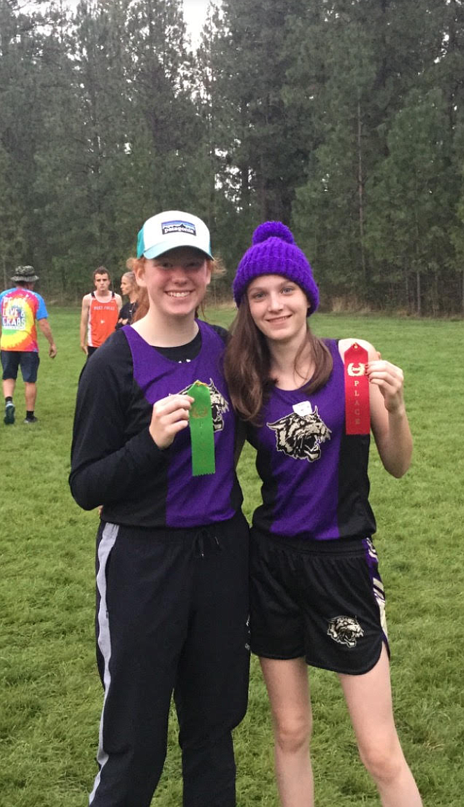 Courtesy image
Kellogg cross country runners Shaye Sullivan (left) and Lacey Medina show off their fifth and second place ribbons (respectively) from the Post Falls JV Meet last week.