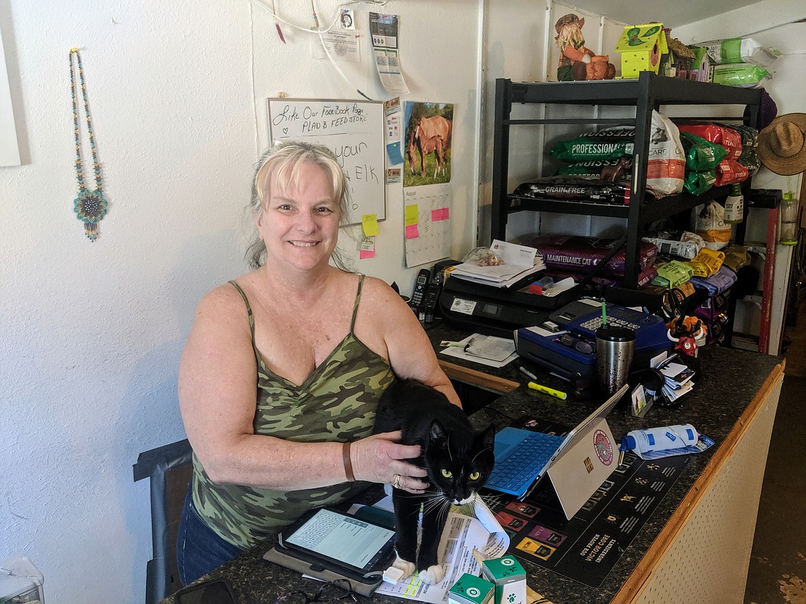 Photo by CHANSE WATSON
Plan B Feed Store owner Brenda Peterson with her cat, Oreo. Oreo lived in the structure before it became Plan B and calls the place home. Peterson&#146;s favorite part of owning the business is helping people with their animals.