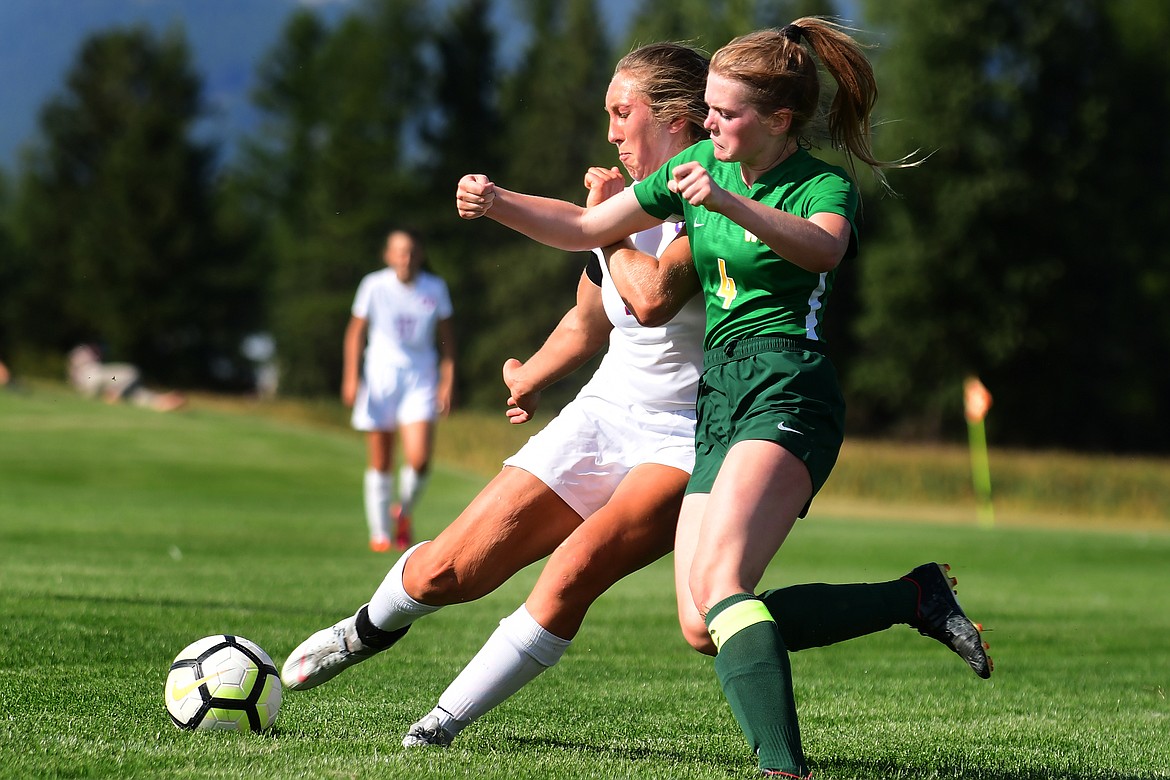 Wildkat forward Josie Windauer kicks the ball past Whitefish defender Mary Peterson.