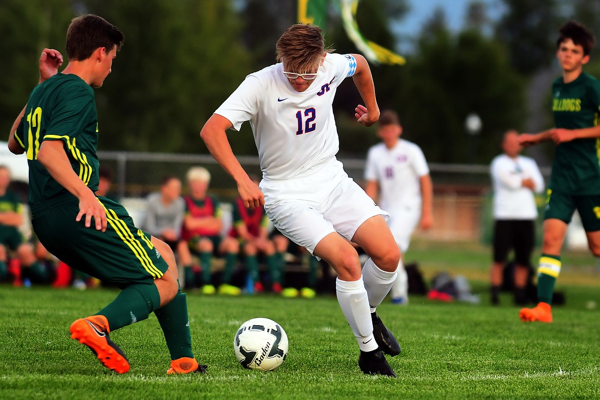 Wildcat Reed Sandstrom take the ball from Bulldog William Hyatt.