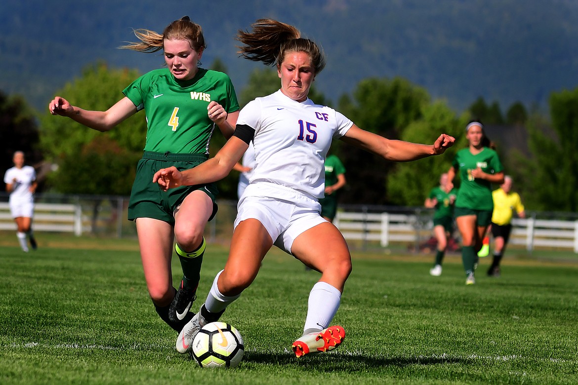 Wildkat Josie Windauer fights off Whitefish&#146;s Mary Peterson for the ball.