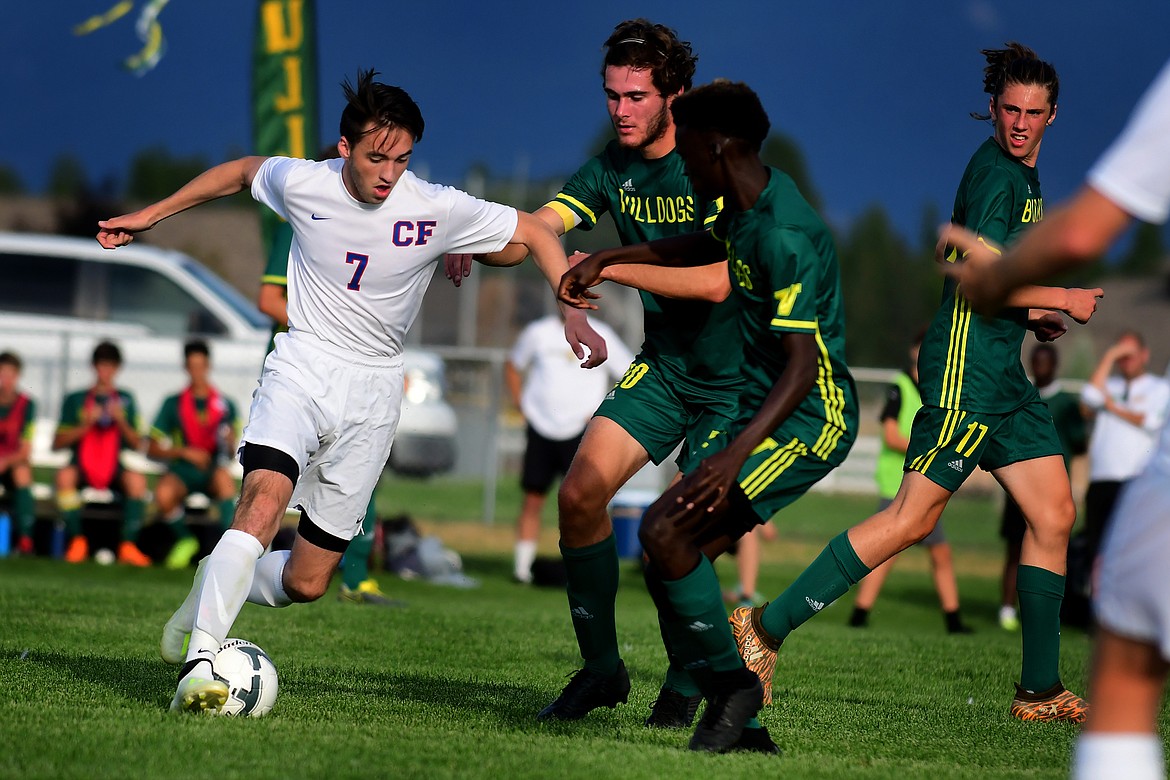 Wildcat Seth Hoffman moves the ball past the Whitefish defense.