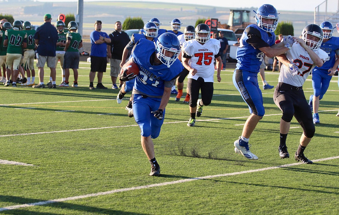 Casey McCarthy/ Sun Tribune
 A Warden High School back runs the ball to the right side of the field against Ephrata at the Royal Football Jamboree on Friday, Aug. 30.