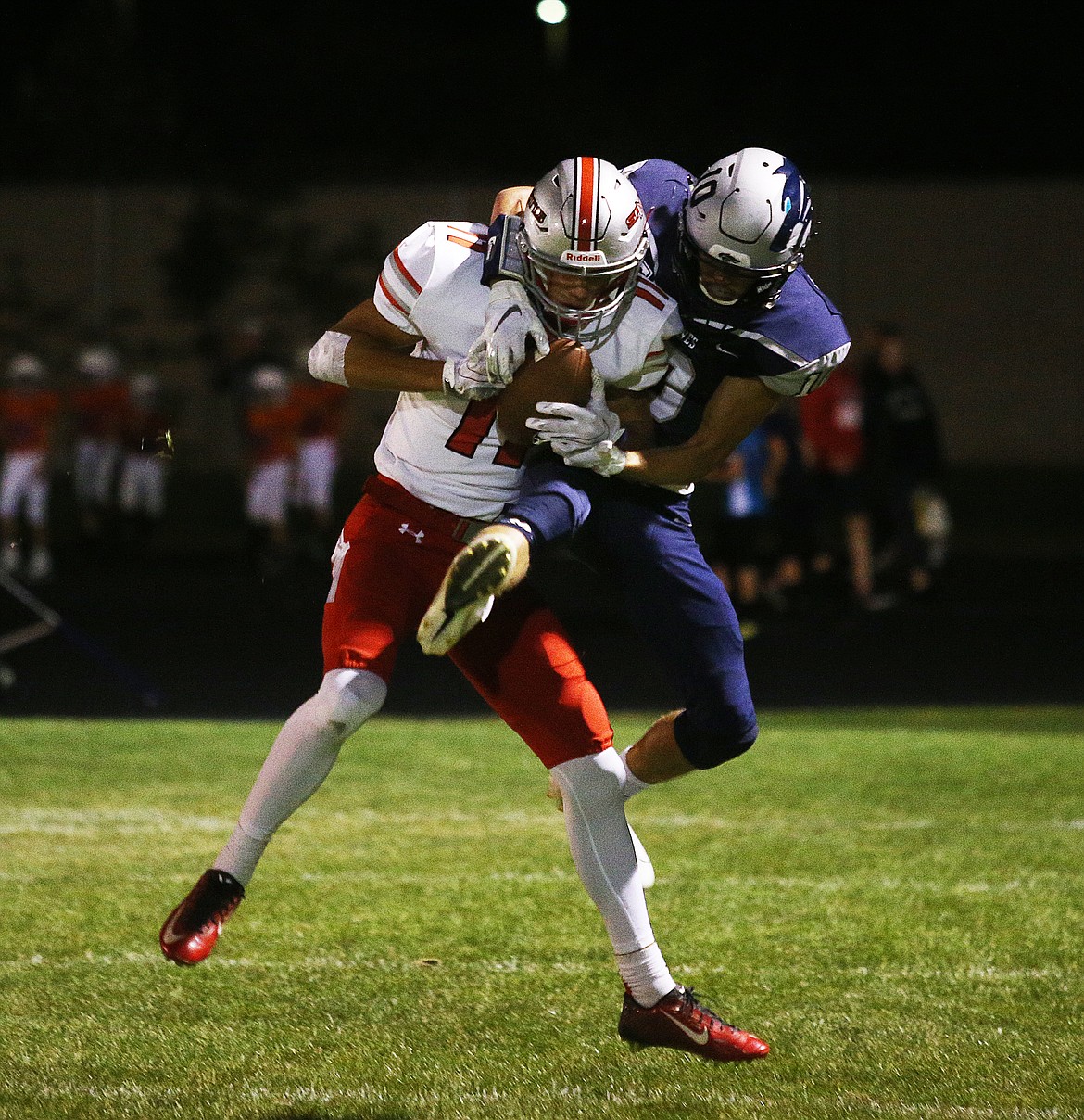 Lake City wide receiver Logan Jeanselme, right, and Ferris defensive back Casey Hocking battle for a pass.