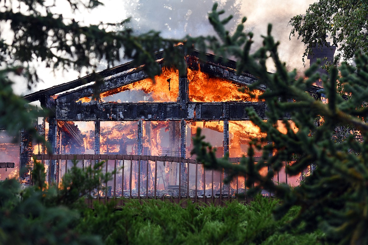 Flames engulf a house on Stonecrest Drive in Kalispell on Thursday afternoon. (Casey Kreider/Daily Inter Lake)