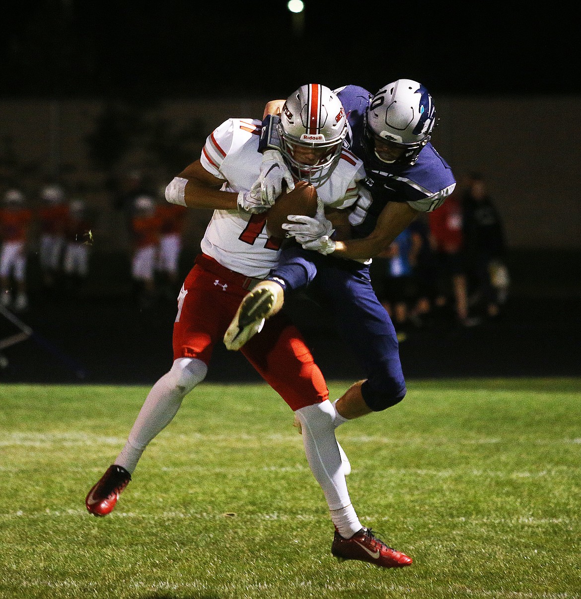 Lake City wide receiver Logan Jeanselme and Ferris defensive back Casey Hocking battle for a pass during Friday nights game at Lake City High. (LOREN BENOIT/Press)