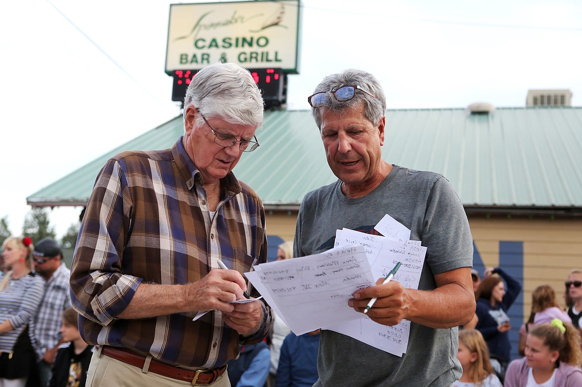 Spinnaker owner Rudy Heinle, right, and a volunteer tally scores after a heat of wiener dog races Sept. 14 in Lakeside. Nearly 30 dachsunds took part in the annual event. (Mackenzie Reiss/Daily Inter Lake)