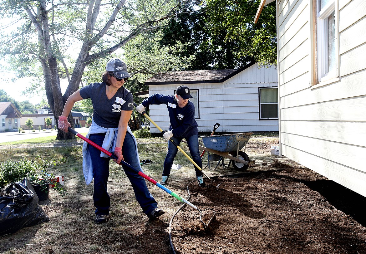 Mountain West Bank employees Marilyn Buroker, left, and Teresa Valk volunteer their time to help with landscaping the front yard of a lot at a Habitat For Humanity project house during United Way&#146;s Day of Caring Thursday. (LOREN BENOIT/Press)