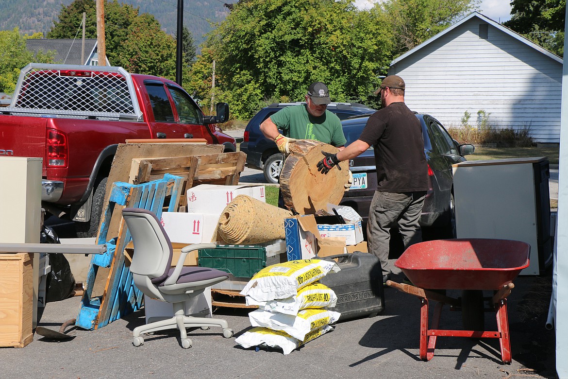 (Photo by CAROLINE LOBSINGER)
Volunteers from Idaho Forest Group help clean up around the Sandpoint Area Seniors, Inc. center. Crews added gravel and leveled the sites&#146; parking lot as well as built shelves, cleaned gutters and organized storage as part of United Way&#146;s Day of Caring volunteer effort in North Idaho.