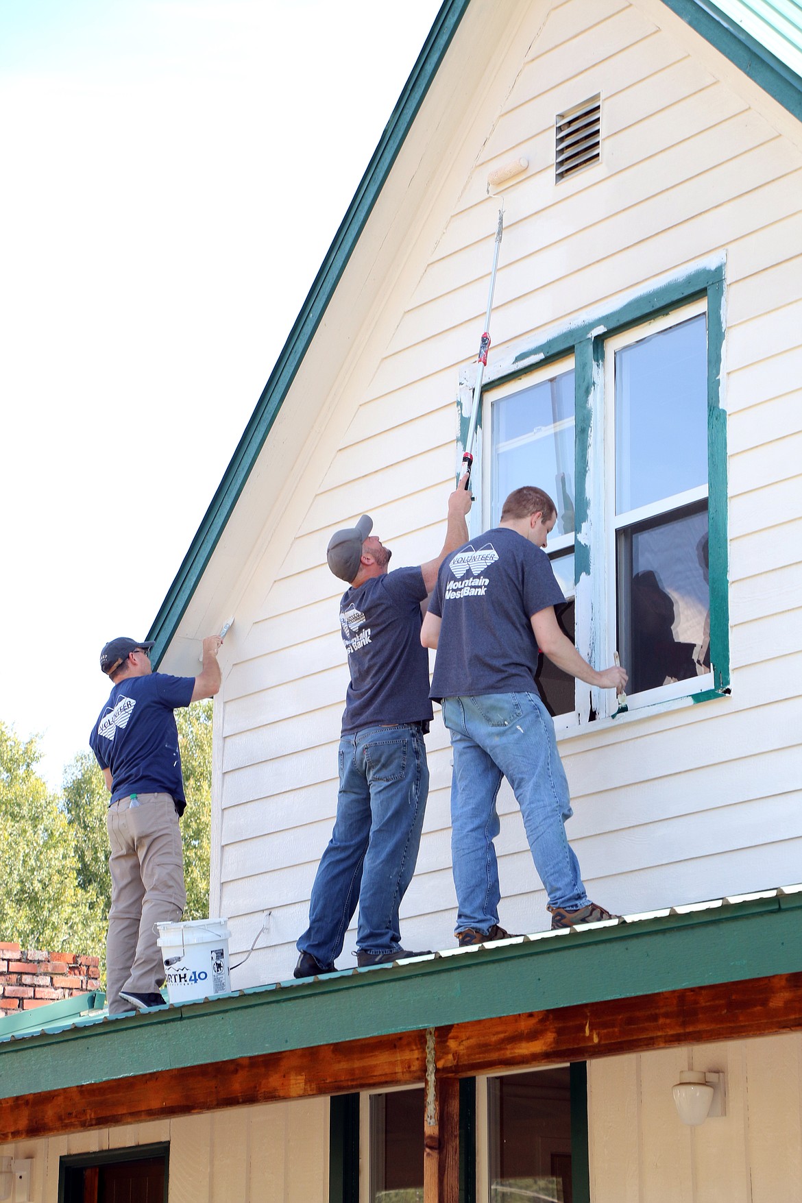 (Photo by CAROLINE LOBSINGER)
Volunteers from Mountain West Bank paint the outside of the Freedom House in Sandpoint. The facility, which is expected to open this fall, will provide a a safe and sober home for men recovering from addiction. Several dozen of the bank&#146;s employees took part in the United Way&#146;s Day of Caring, a day dedicated to volunteerism and helping others.