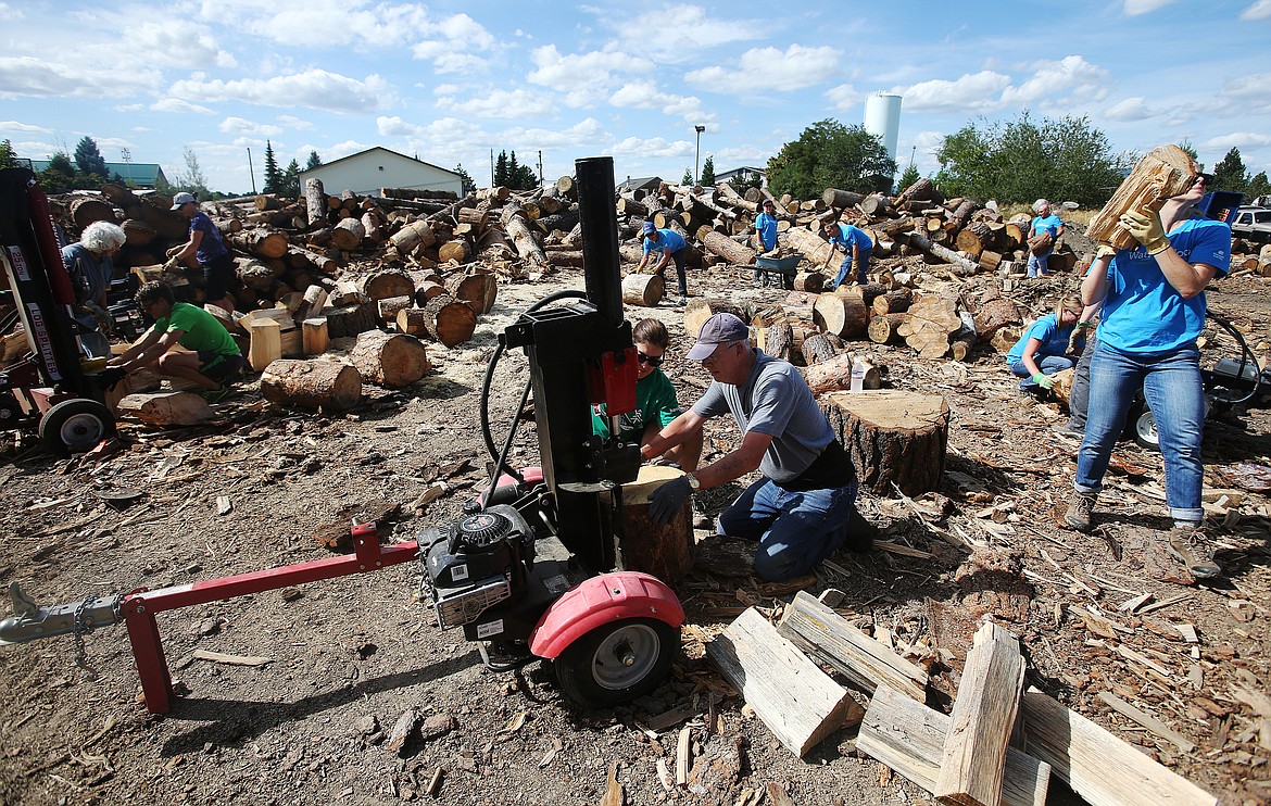 LOREN BENOIT/Press
Ashley Lenz, with Bank CDA, and Skip Priest, with Coeur d&#146;Alene Rotary, help split wood for ElderHelp during United Way&#146;s Day of Caring on Thursday.