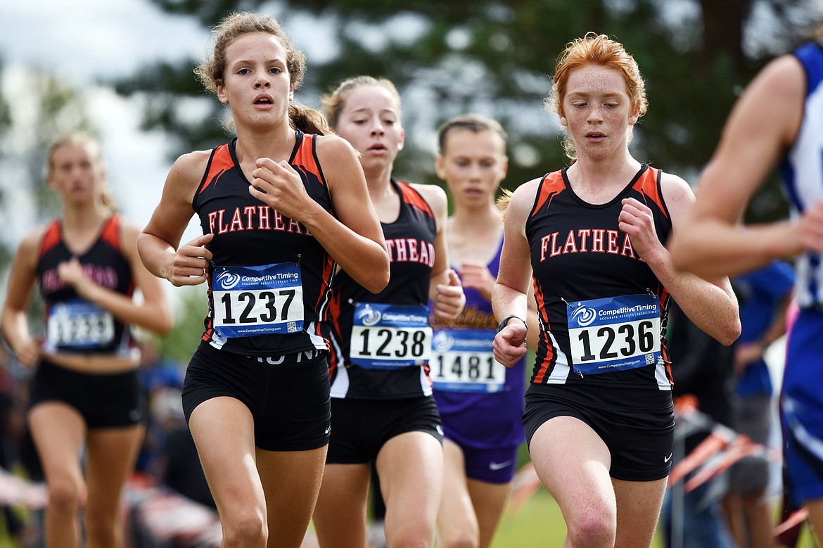 Flathead's Neila Lyngholm, left, Tori Noland-Gillespie, back, and Madelaine Jellison, right, all took home top 10 finishes at the Flathead Invite at Rebecca Farm on Saturday. Jellison placed 6th with a time of 20:12.72; Lyngholm placed 7th with a time of 20:13.01; and Noland-Gillespie placed 10th with a time of 20:23.57. (Casey Kreider/Daily Inter Lake)