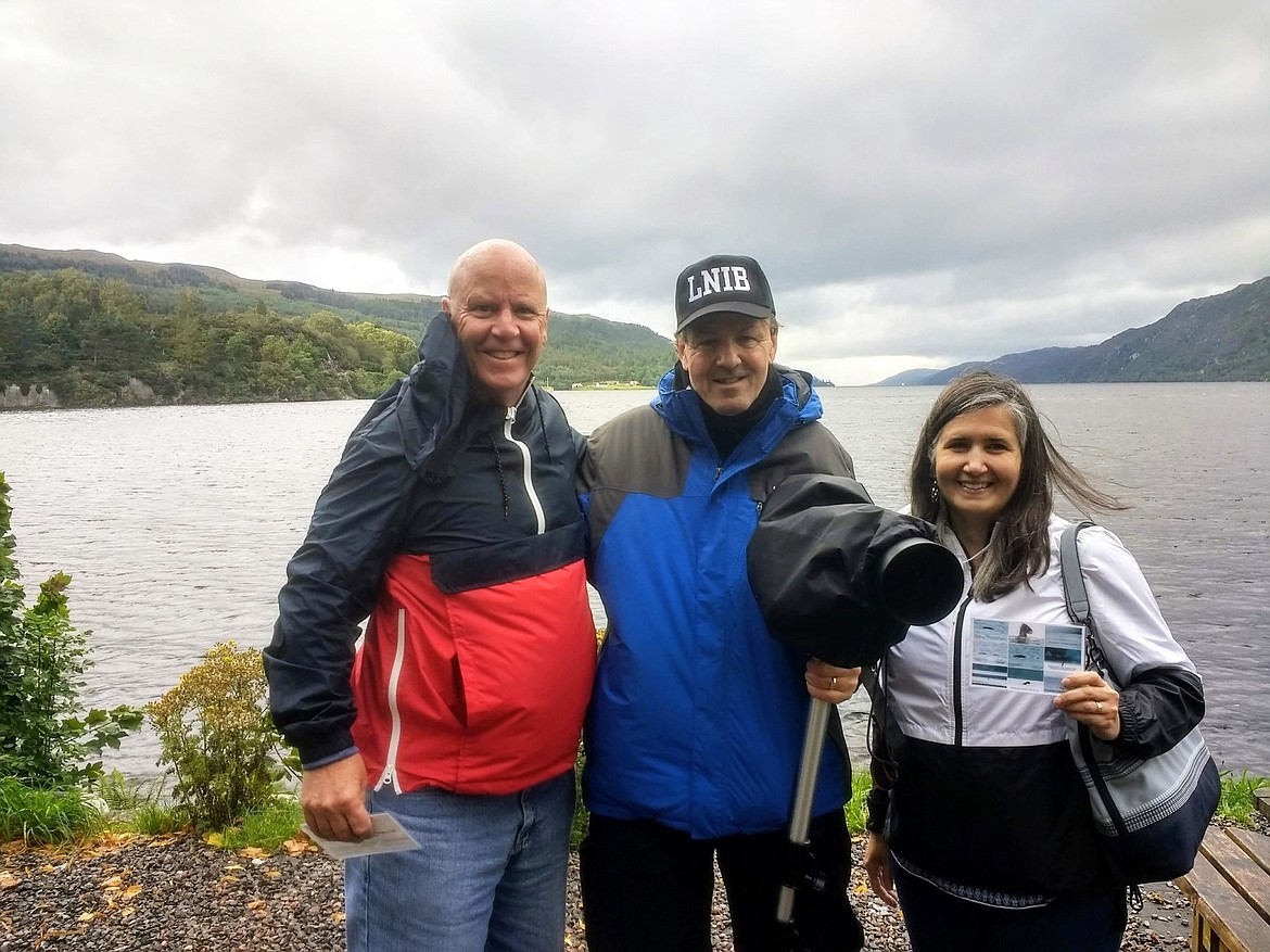 Sholeh and Mike Patrick stand with monster-hunter William Jobes of Fort Augustus, Scotland at the top of Loch Ness. Jobes&#146; hat stands for &#147;Loch Ness Investigation Bureau&#148; (Photo by Lyn MacDonald).