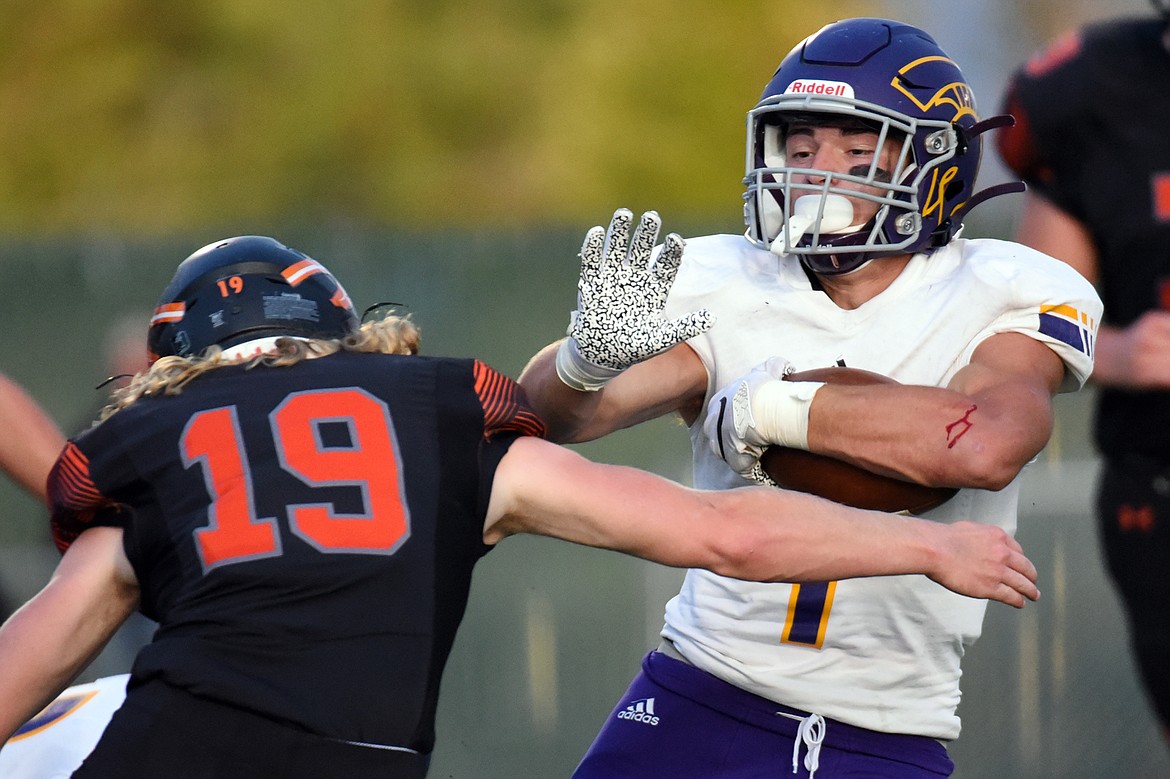 Missoula Sentinel running back Jaxon Lee (1) breaks a tackle by Flathead's Kyle Fear (19) at Legends Stadium on Friday. (Casey Kreider/Daily Inter Lake)