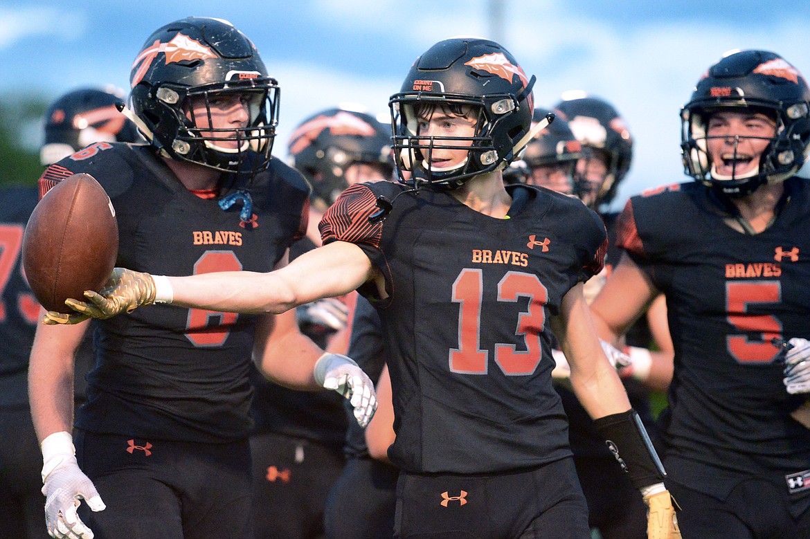 Flathead's Brian Wells (13) flips the ball to a referee after a first-quarter interception against Missoula Sentinel at Legends Stadium on Friday. (Casey Kreider/Daily Inter Lake)