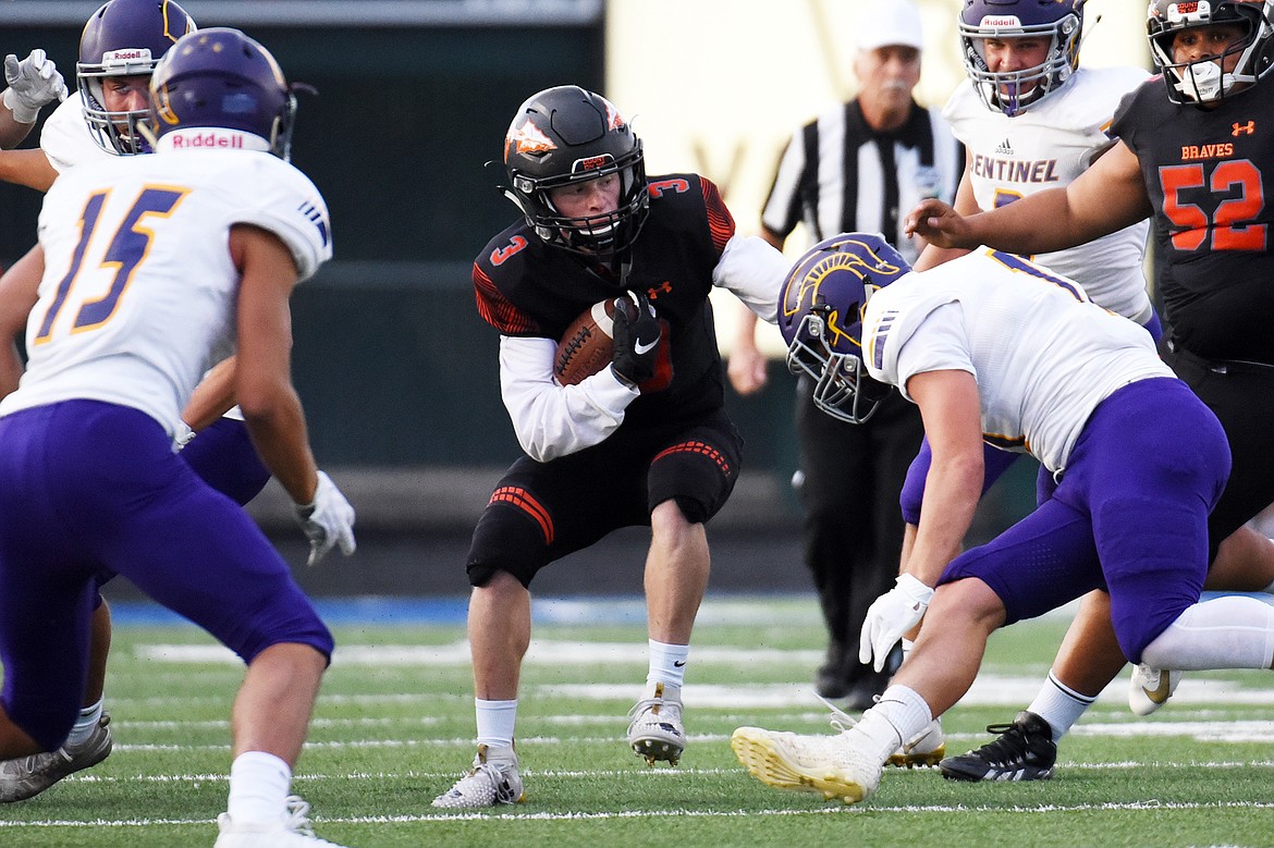 Flathead running back Chance Sheldon-Allen (3) looks for running room against the Missoula Sentinel defense at Legends Stadium on Friday. (Casey Kreider/Daily Inter Lake)