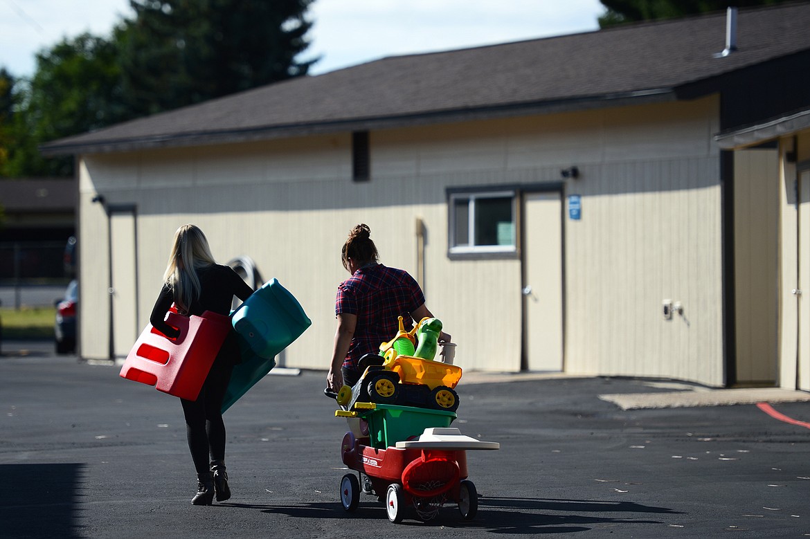 Teachers transport toys and instructional materials between buildings for classes at Glacier Gateway Elementary School in Columbia Falls on Wednesday, Sept. 11. (Casey Kreider/Daily Inter Lake)
