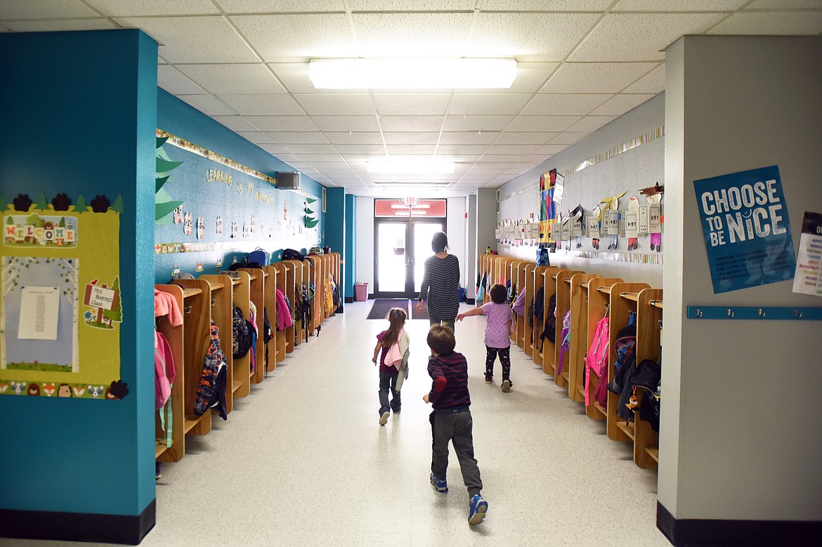 A teacher and students walk toward an exit that leads to a breezeway separating the two school buildings at Ruder Elementary School in Columbia Falls on Wednesday, Sept. 11. (Casey Kreider/Daily Inter Lake)