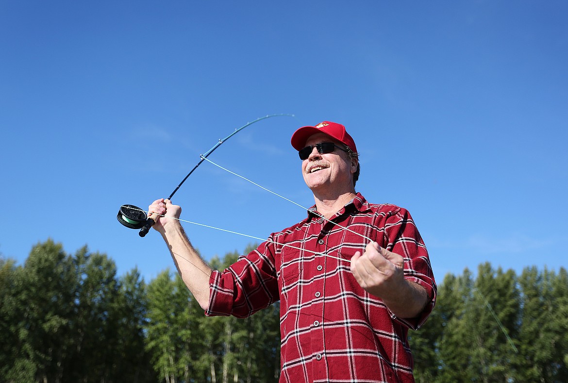 Joe Walsh, of Hungry Horse, casts off the bank of the Flathead River Thursday morning during a fly fishing outing organized by Flathead Valley Trout Unlimited. (Mackenzie Reiss/Daily Inter Lake)