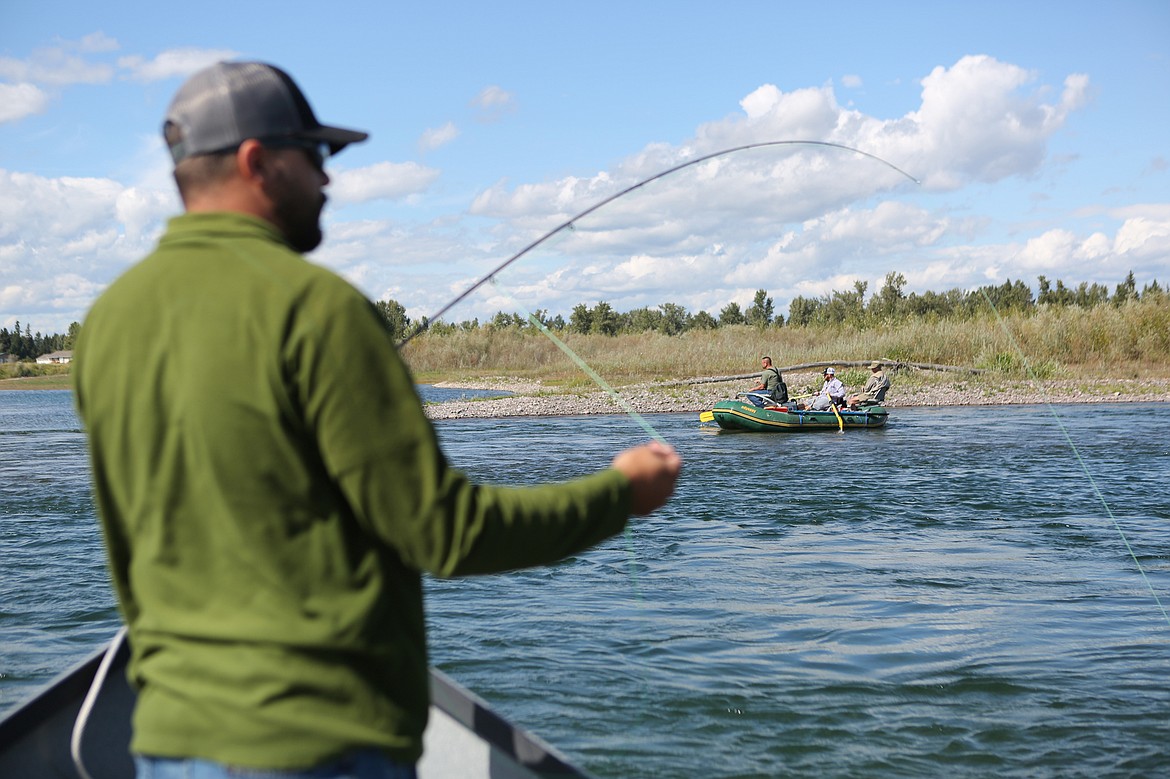 Army veteran Travis XXXXX fishes on the Flathead River, along with five other local veterans, on Sept. 12. (Mackenzie Reiss/Daily Inter Lake)