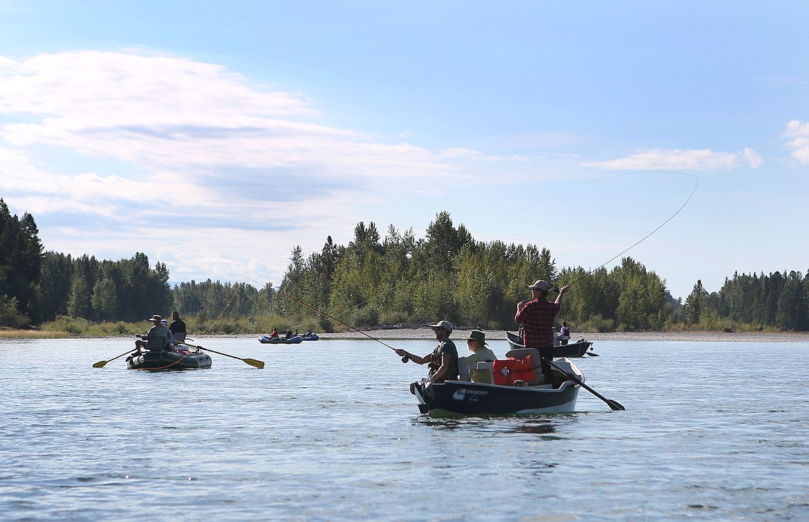 Veterans AJ Lee of Kalispell, left, and Joe Walsh of Hungry Horse fish from a drift boat on the Flathead River during a fly-fishing outing hosted by Flathead Valley Trout Unlimited.