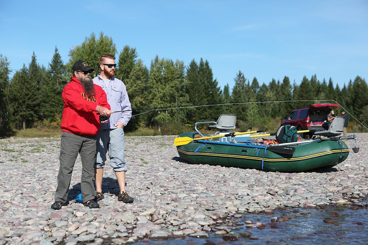 Marine Corps veteran Martin Cole, of Kalispell, (left) practices casting on the shore of the Flathead River on Sept. 12. (Mackenzie Reiss/Daily Inter Lake)