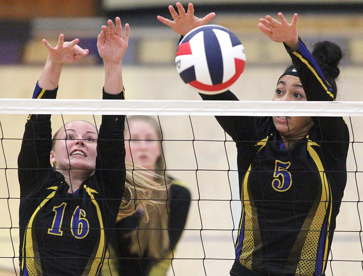 KYLEE QUINN, left, and Olivia Gilliam Smith block in the second game against Sandpoint Sept. 12. Sandpoint won in four sets. (Paul Sievers/The Western News)