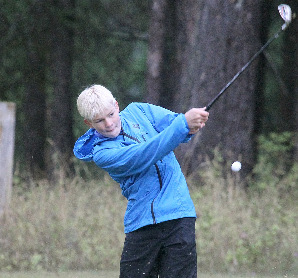 LIBBY FRESHMAN Thomas Roark hits a second shot on No. 7 at the Libby Invitational. (Paul Sievers/The Western News)