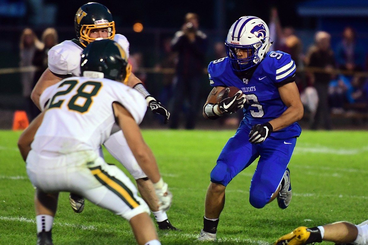 Wildcat Isaac Balla looks for running room against Whitefish linebacker Zach Veneman. (Jeremy Weber photo)