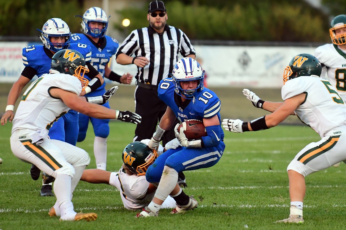 Wildcat receiver Cade Morgan looks to evade the Whitefish defense. (Jeremy Weber photo)