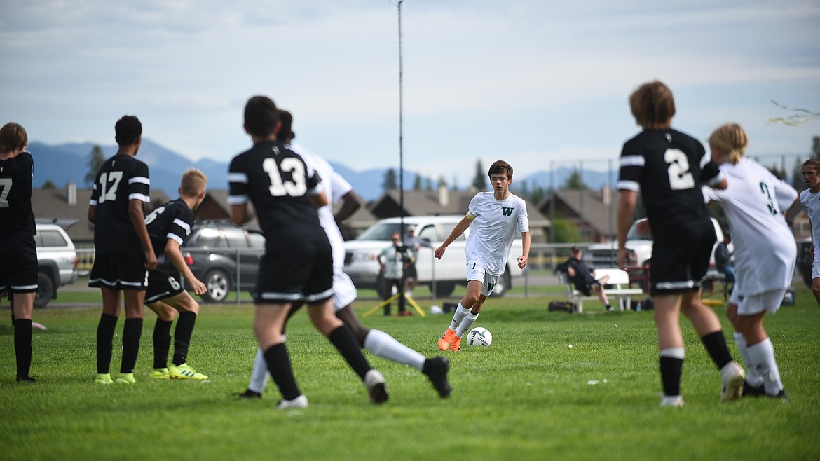 Ian Lacey gets ready to attack the Billings defense. (Daniel McKay/Whitefish Pilot)