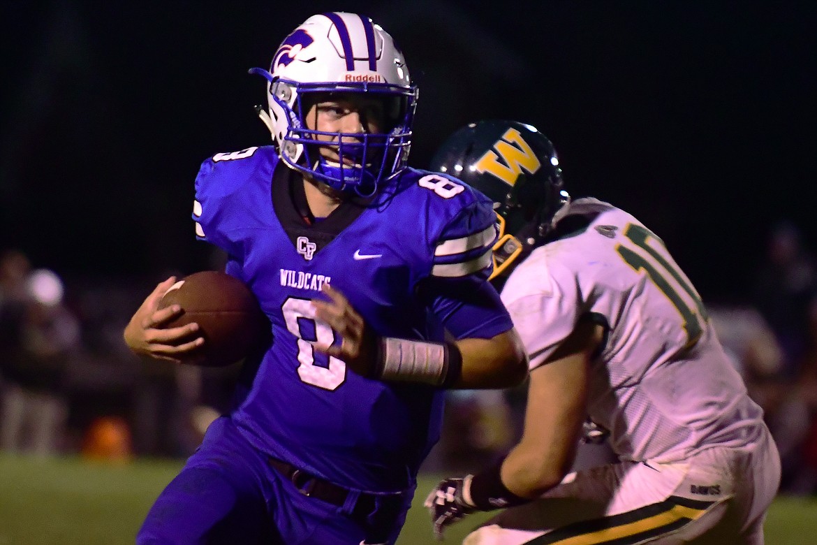 Wildcat quarterback Mason Peters breaks to the outside in the fourth quarter Friday. (Jeremy Weber photo)