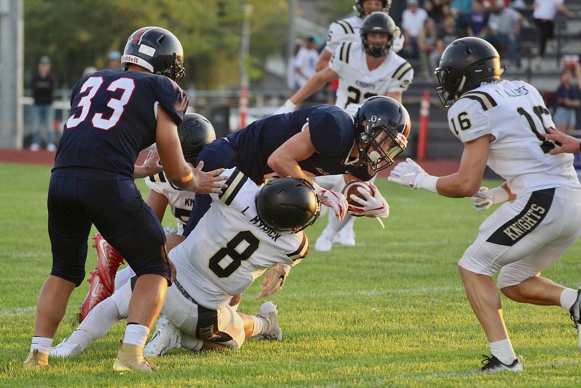 Casey McCarthy/ Columbia Basin Herald Lorenzo Myrick combines with another Royal defender to bring down the Ellensburg player in the first half on Friday.