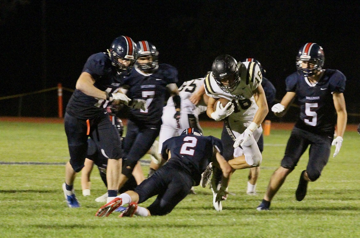 Casey McCarthy/ Columbia Basin Herald Royal Quarterback Caleb Christenen powers forward as the Ellensburg defense collapse on him during the second half on Friday evening.