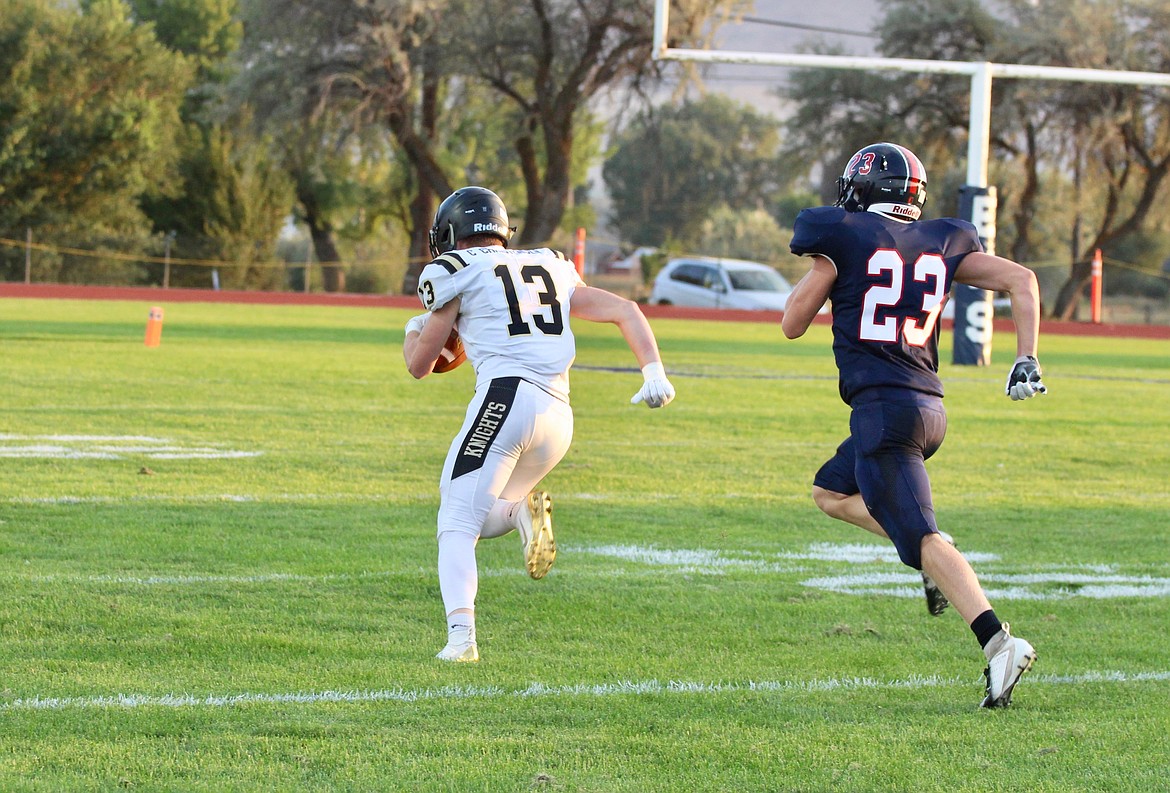 Casey McCarthy/ Columbia Basin Herald Cooper Christensen runs in for his first touchdown of the day off the pass from Derek Bergeson on the opening drive for the Knights.