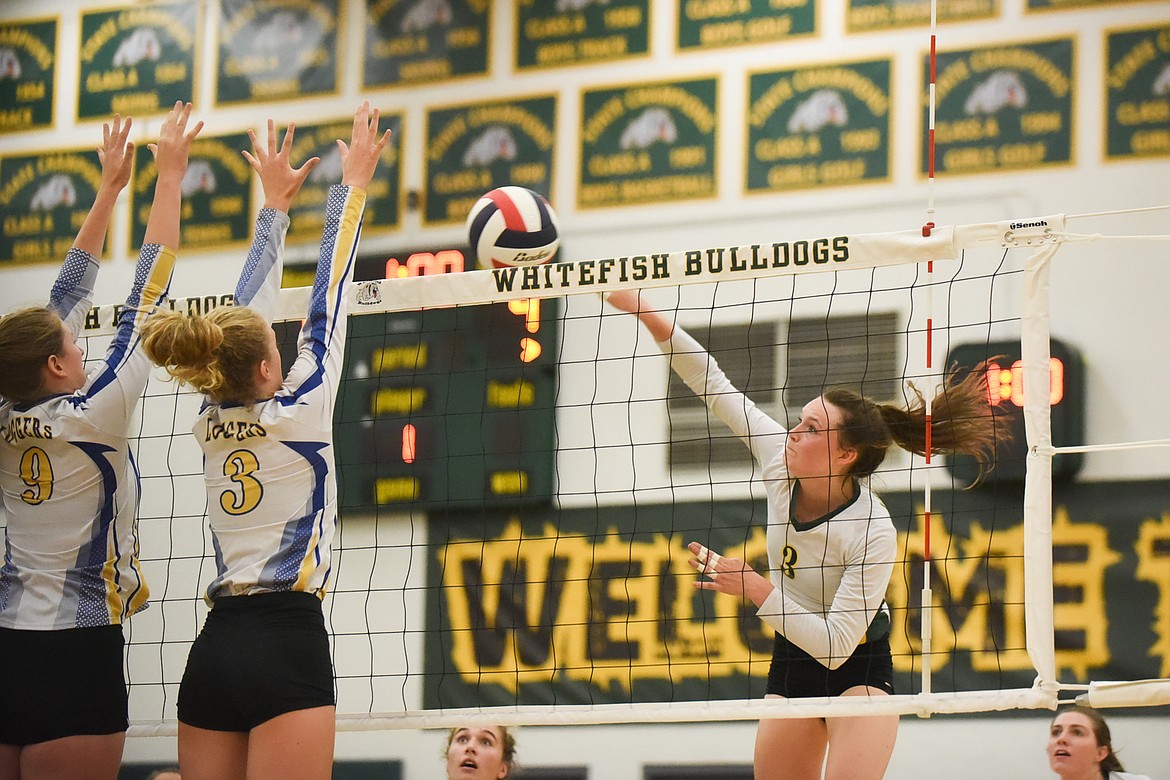 Kaiah Moore goes up for the spike against Libby last Thursday. (Daniel McKay/Whitefish Pilot)