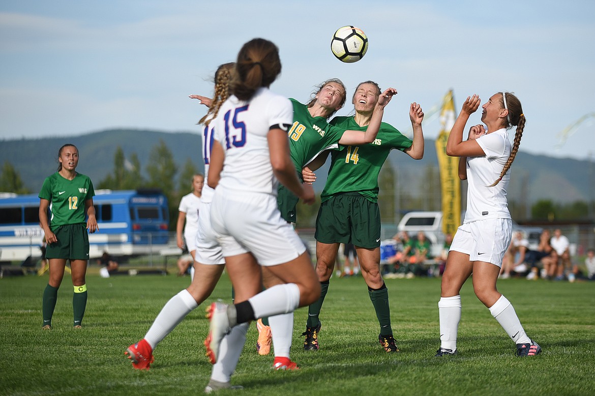 Two Lady Dogs nearly collide for a header that would score their second goal during last Tuesday's loss to Columbia Falls. (Daniel McKay/Whitefish Pilot)