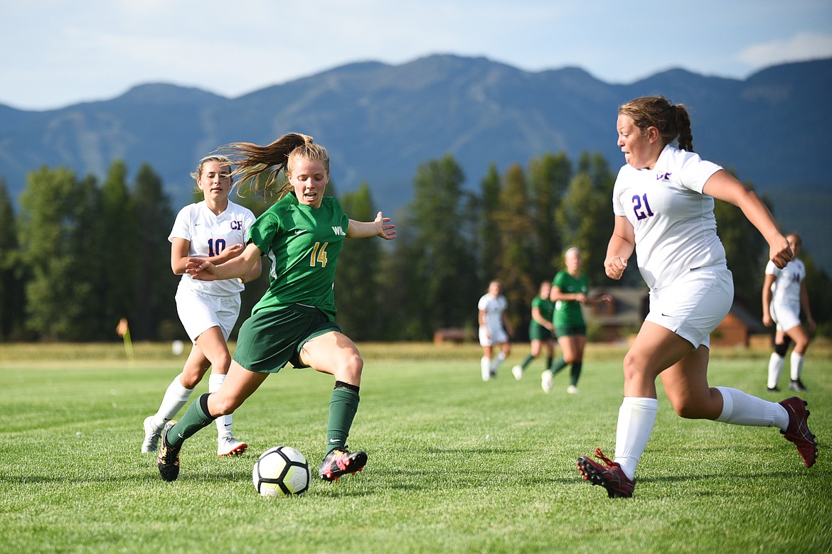 Josie Schneider fights through the defense during last Tuesday's loss to Columbia Falls. (Daniel McKay/Whitefish Pilot)