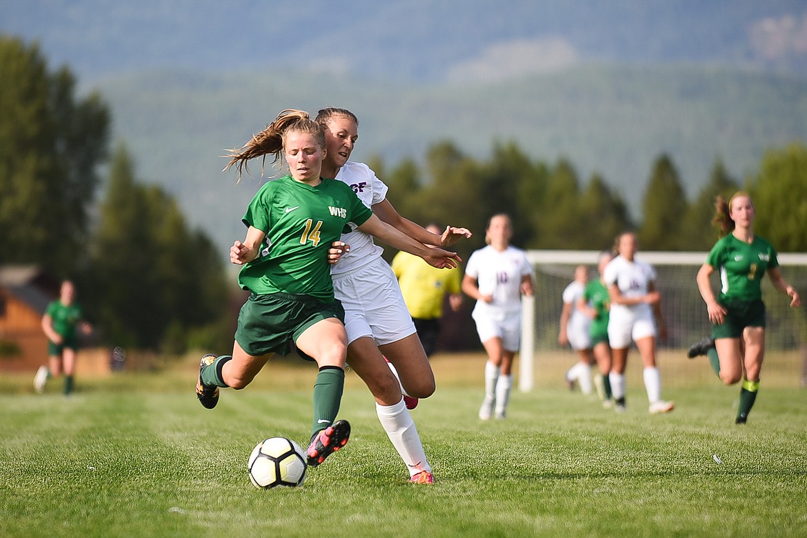 Josie Schneider fights off a Wildkat during last Tuesday's loss to Columbia Falls. (Daniel McKay/Whitefish Pilot)