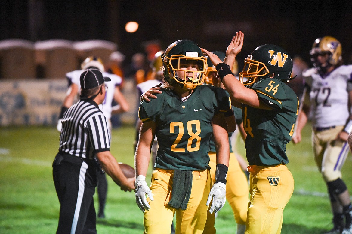 Zach Veneman's teammates congratulate him after a touchdown. (Daniel McKay/Whitefish Pilot)