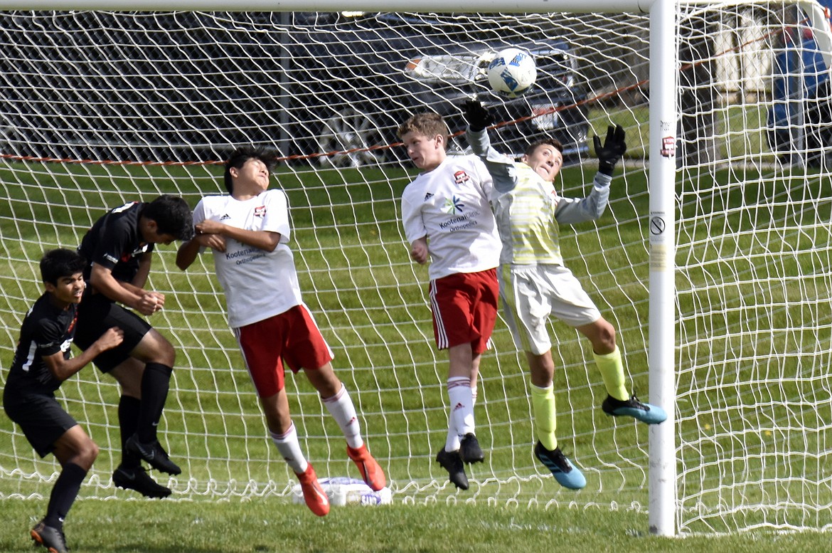 Photo by SUZI ENTZI
Saturday, the Timbers North FC 06 Boys Red soccer team beat Snohomish United B06 BlackA 2-1. Connor Jump and Noah Waddell each had one goal for the Timbers. On Sunday, the Timbers fell to Crossfire Premier B06C 4-1. Kai Delio had one goal and Connor Jump had one assist for the Timbers. Pictured are three Timbers players (in white) reacting to a header &#151; from left, Chief Natatqn Allen, Connor Jump and goalkeeper Braden Latscha.