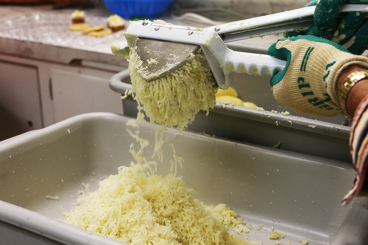 Paul Hunt presses a potato through a ricer to make lefse Tuesday at Trinity Lutheran Church in preparation for the church's holiday bazar. (LOREN BENOIT/Press)