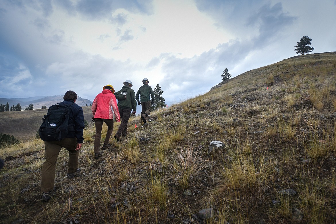 Amy Grout and members of the Montana Conservation Corps head uphill on a social trail that members of the Corps have been improving on Wild Horse Island State Park on Thursday, Sept. 19. (Casey Kreider/Daily Inter Lake)