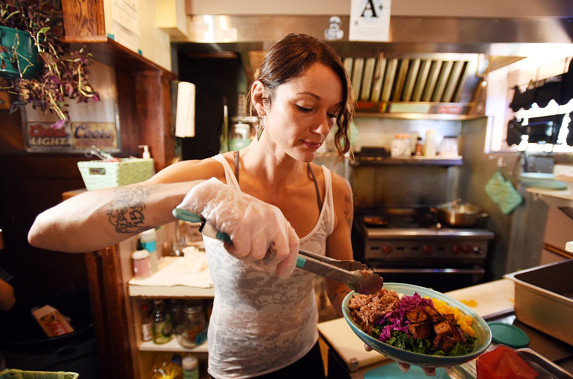 Stefanie Bridges makes a Rebel Rice bowl on Sept. 26 at Rebel Roots, the kitchen she&#146;s opened inside the Palace Bar in Whitefish. Bridges referred to the small space as being similar to her own food truck, but without the wheels. (Brenda Ahearn photos/Daily Inter Lake)